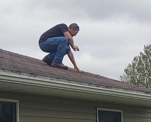 Todd climbing on roof during home inspection